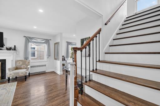 A beautiful staircase ascending to the private upper level, home to three spacious bedrooms