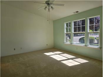 Vaulted ceilings and abundant natural light create a spacious and peaceful primary retreat.