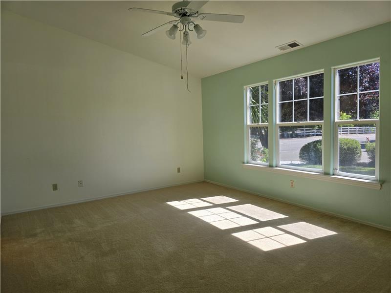 Vaulted ceilings and abundant natural light create a spacious and peaceful primary retreat.