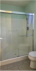 The clean step-in shower design offers both convenience and easy accessibility for everyday comfort.