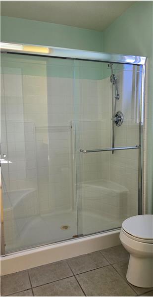 The clean step-in shower design offers both convenience and easy accessibility for everyday comfort.