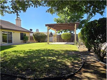 Just outside, the kind of backyard many of us dreamed about growing up  expansive green lawn, beautiful shade, warm sunshine.