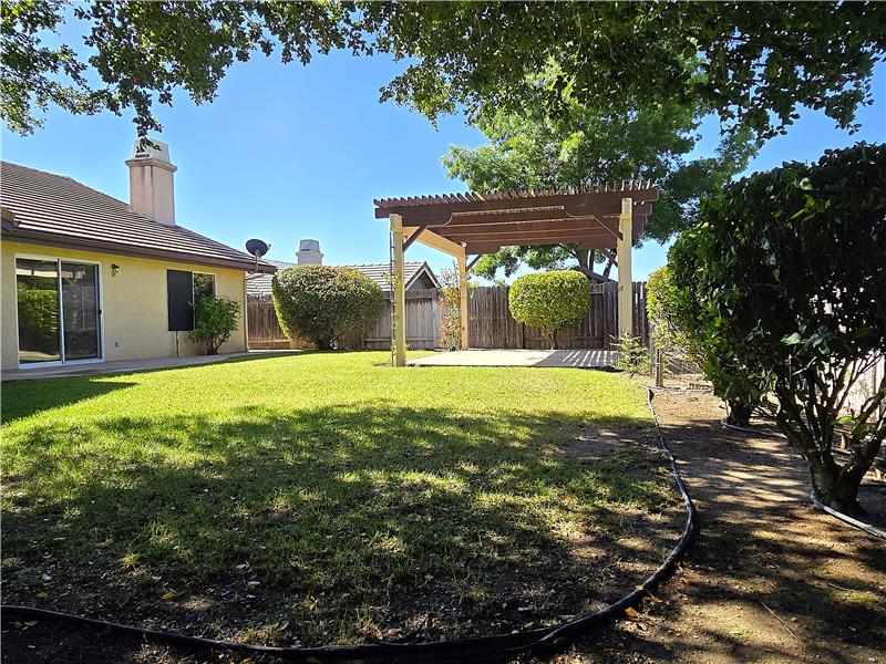 Just outside, the kind of backyard many of us dreamed about growing up  expansive green lawn, beautiful shade, warm sunshine.