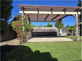 This expansive pergola transforms the backyard into an inviting extension of the home itself.