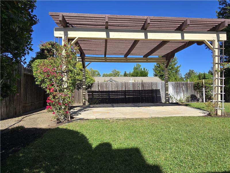 This expansive pergola transforms the backyard into an inviting extension of the home itself.