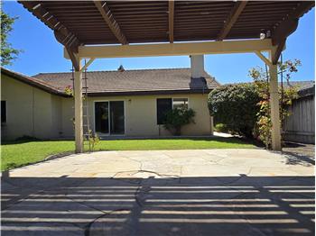 The pergola extends the usability of the backyard by offering shaded comfort without sacrificing natural light.