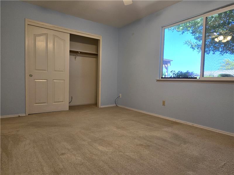 Natural afternoon sunlight filters beautifully into West-facing Bedroom 3.