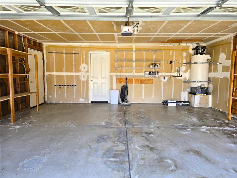 The oversized garage layout comfortably accommodates full-size vehicles while still allowing room for storage & workspace flex!