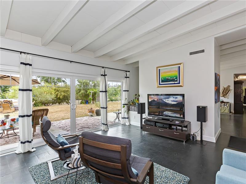 TV Room with beamed ceiling and built-ins