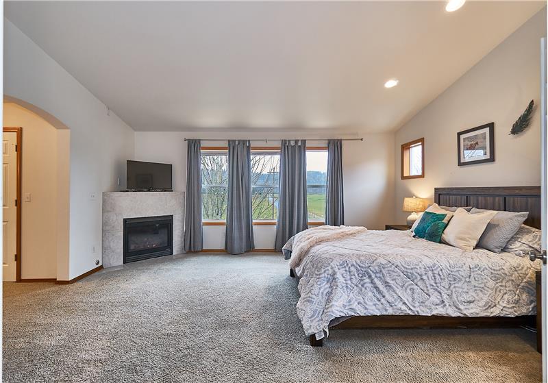 Huge Master Bedroom with a Tile Surround, Gas Fireplace.