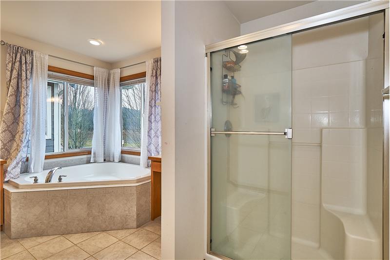 Large Master Bathroom with Tile Floors, Shower and Large Soaking Tub.