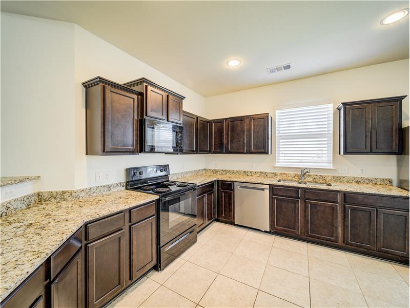 Gourmet kitchen with granite countertops and stainless steel appliances 