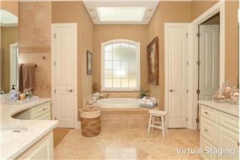 Virtually Staged Primary Bath with light colored vanities & counters