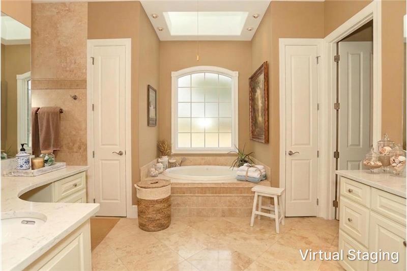 Virtually Staged Primary Bath with light colored vanities & counters