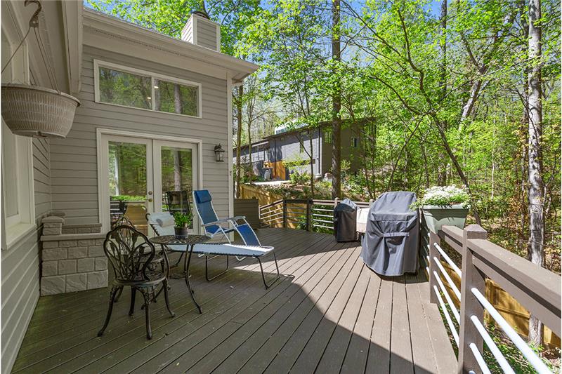 Large oversized deck overlooking wooded lot