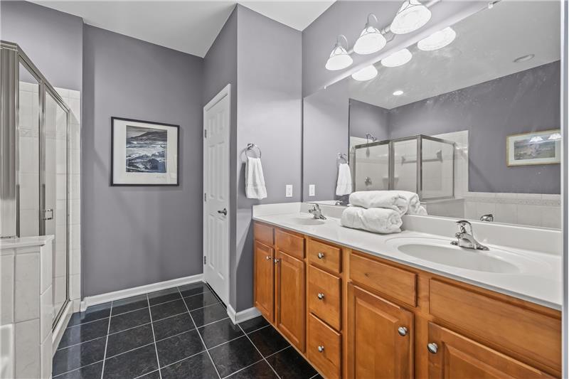 Primary en-suite bath with expanded double sink vanity, private WC