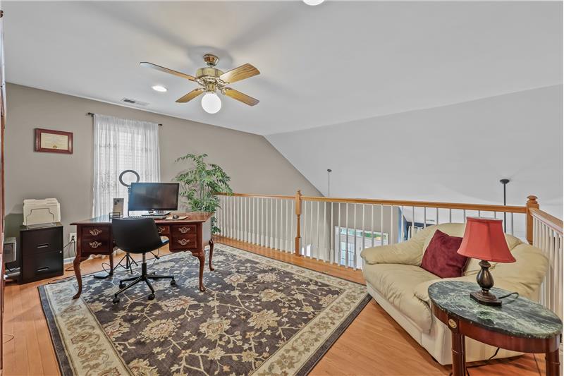 Second floor loft with hardwood floors is great flex space