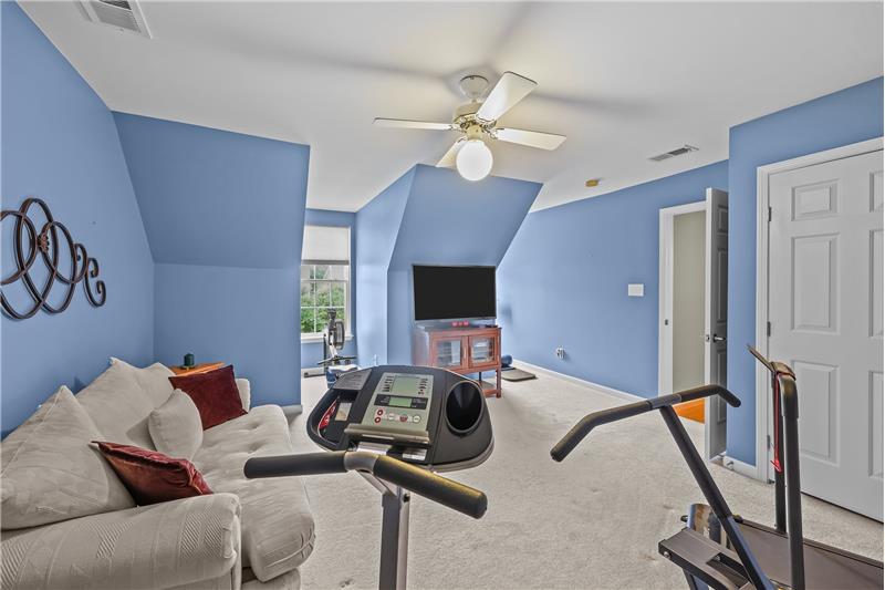 One of two additional large bedrooms on second floor, current used as a workout room