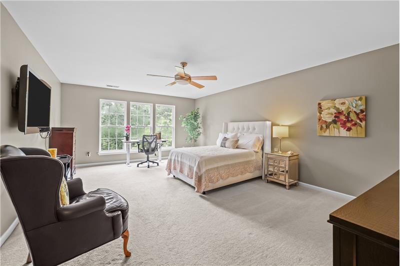 Second primary suite on upper floor with walk-in closet, en-suite bath