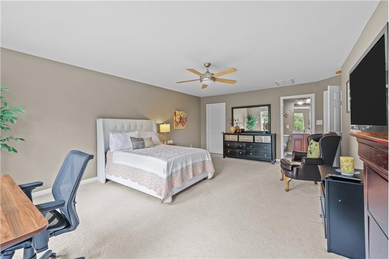 Second primary suite with room for king side bed, sitting  and desk area,