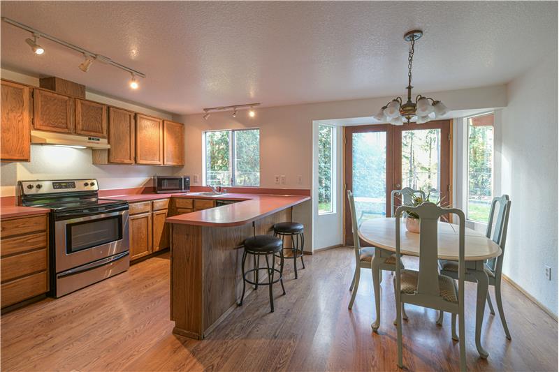 Kitchen and dining room with french doors to the backyard.