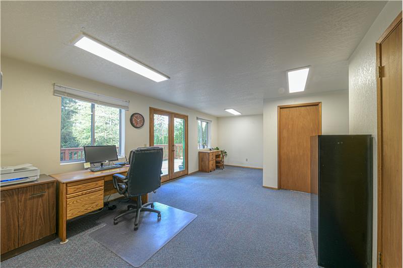 Upstairs office with room for three desks. Separate entry on deck from outside stairwell.