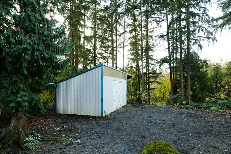 Two-stall barn with 12' covered run-in.