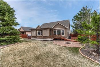 Backyard oasis with mature landscaping, auto sprinklers, a large wood deck, pergola, hot tub, fire pit, & dog run.