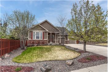 Great curb appeal with low maintenance landscaping with trees, green grass, and rock gardens.