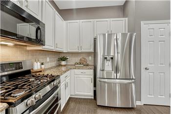 Appliances include a gas range with double ovens, microwave, dishwasher, and French door refrigerator.