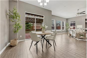 Dining Area with attractive light fixture and slider to the backyard deck with pergola.