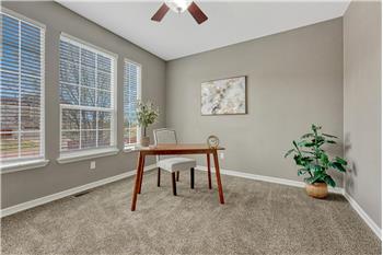 Main Level Bedroom #2 with neutral carpet and lighted ceiling fan.