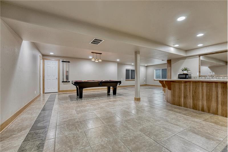 Basement Family Recreation Room with game area and wet bar/kitchenette.