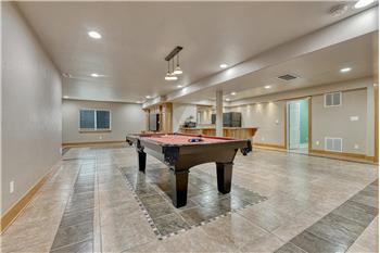 The Family Rec Room features ceramic tile flooring, and a pool table with pendant light that is included.