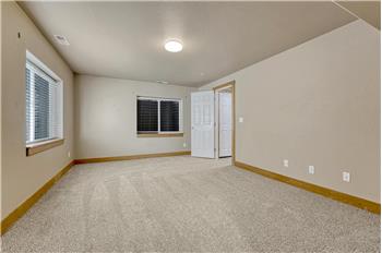 Basement Bedroom #5 has neutral carpet and access to the Basement Bathroom.