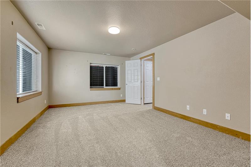 Basement Bedroom #5 has neutral carpet and access to the Basement Bathroom.