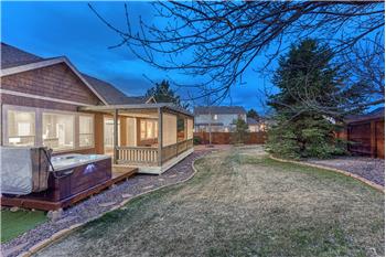 Sunset views of the Backyard with auto sprinklers, mature trees, built-in fire pit, deck, pergola, and hot tub..