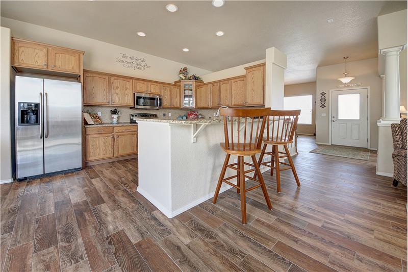 Spacious kitchen with breakfast bar and recessed lighting