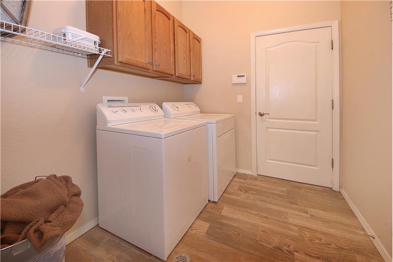 Main level laundry with upper cabinets