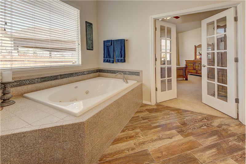 Master bath with French doors and jetted tub