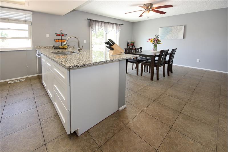 Tile flooring throughout the kitchen and dining area