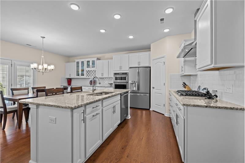 Beautifully appointed kitchen with granite, pantry, stainless steel appliances