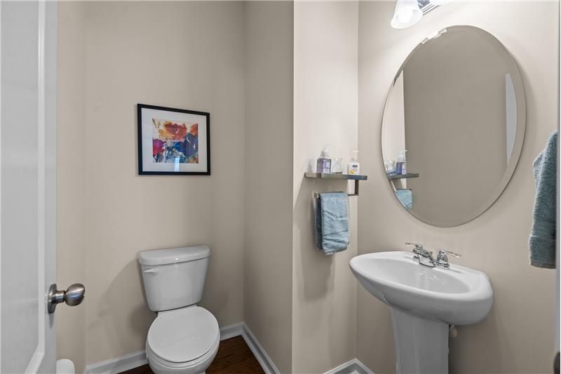 Powder room with hardwood floors, pedestal sink