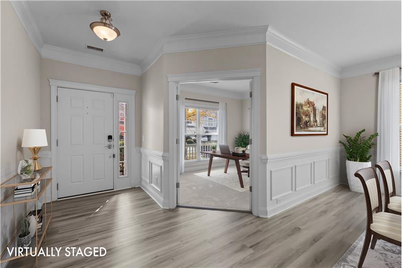 Foyer with generous millwork provides a gracious introduction to the home.