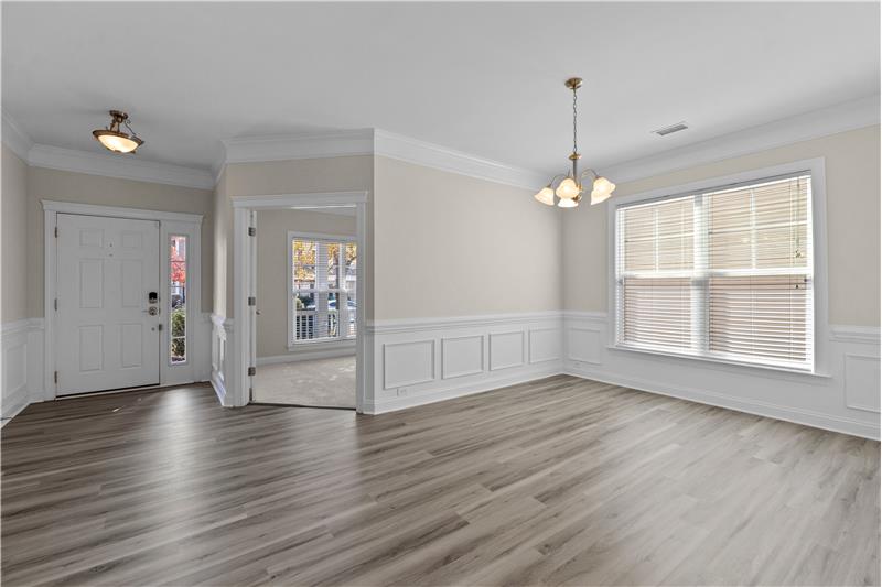 Dining room features brand new luxury vinyl plank floors and generous millwork. Freshly painted.