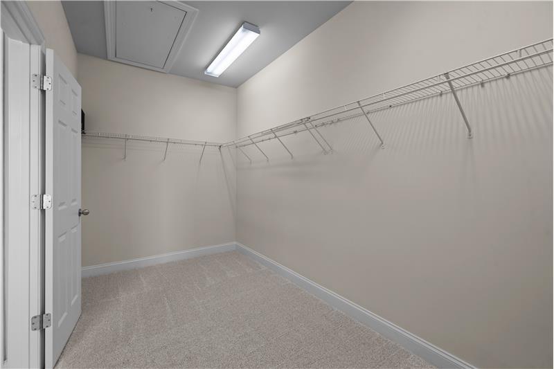 En-suite, walk-in closet in owner's suite is freshly painted, has new wall-to-wall carpet.