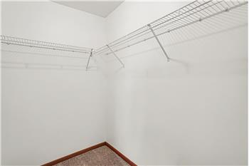 Walk in closet primary bedroom
