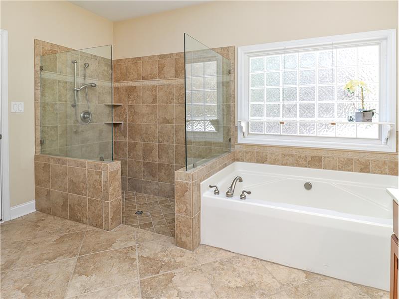 Oversized tile shower with frameless glass doors