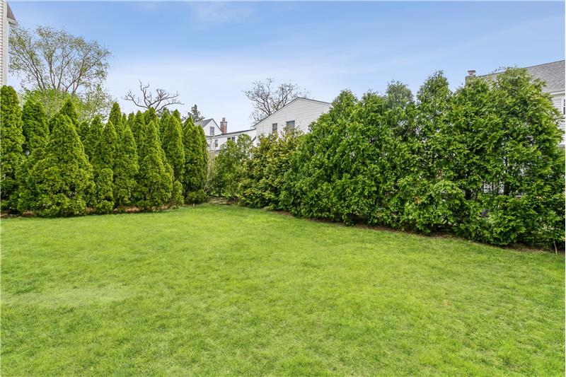 Mature evergreen hedges wrap this level, backyard in complete privacy  creating a park-like sanctuary that you can enjoy!