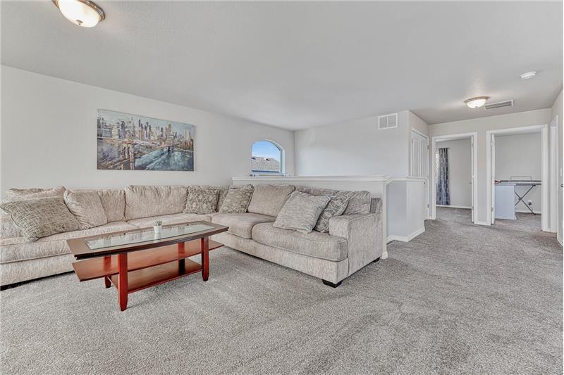 Spacious upper level Loft/Family with neutral carpet.